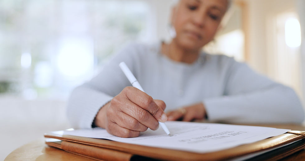 a person sitting at a desk writing in a notebook