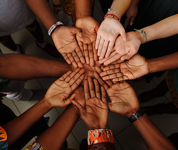 many hands coming together of all races