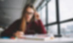 a person sitting at a desk studying