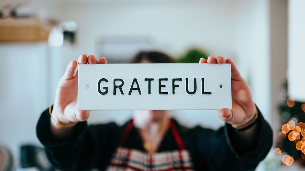 person holding a sign that says grateful
