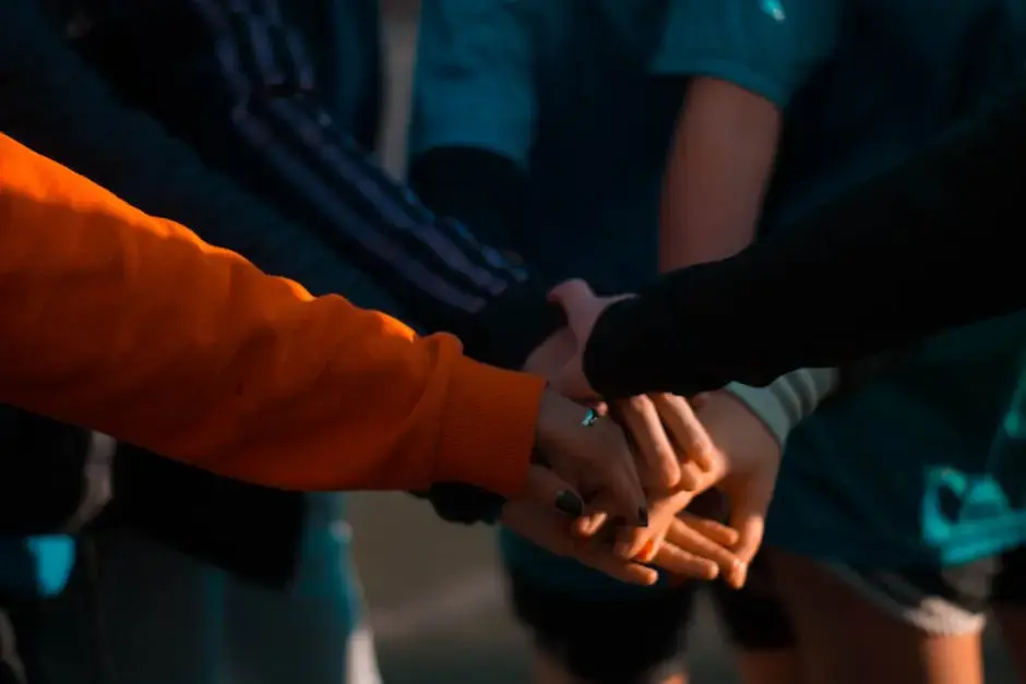 a group of five hands held on top of each other