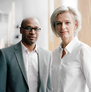two individuals standing confidently