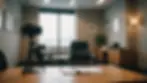 Eye-level view of interview room with a single chair and notepad