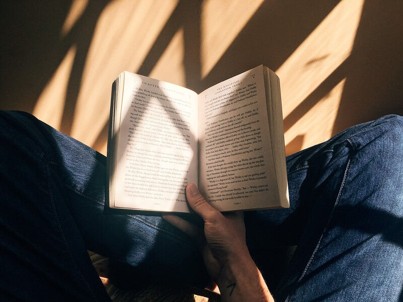 person holding a book in their lap